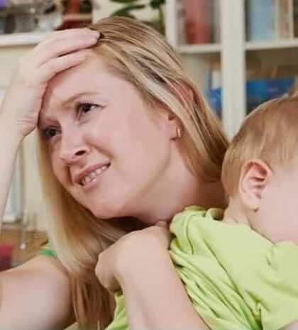 Woman with baby is anguished, overwhelmed
